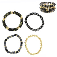 4-PIECE ASSORTED ACRYLIC BEADED AND SPECKLED BAMBOO TUBE STACKABLE BANGLE BRACELET SET WITH GOLD TONE METAL ACCENTS