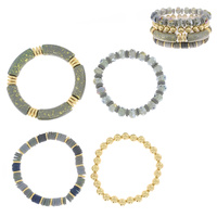 4-PIECE ASSORTED ACRYLIC BEADED AND SPECKLED BAMBOO TUBE STACKABLE BANGLE BRACELET SET WITH GOLD TONE METAL ACCENTS