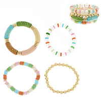 4-PIECE ASSORTED ACRYLIC BEADED AND SPECKLED BAMBOO TUBE STACKABLE BANGLE BRACELET SET WITH GOLD TONE METAL ACCENTS