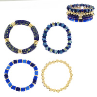 4-PIECE ASSORTED ACRYLIC BEADED AND SPECKLED BAMBOO TUBE STACKABLE BANGLE BRACELET SET WITH GOLD TONE METAL ACCENTS