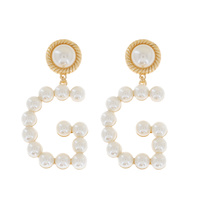 G INITIAL PEARL STUDDED DANGLE AND DROP EARRINGS IN GOLD TONE METAL