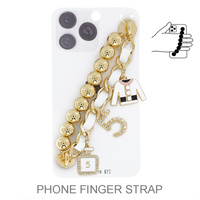 ENAMEL COATED CRYSTAL RHINESTONE PAVE MULTI CHARM BEADED AND LEATHER WOVEN CHAIN PHONE STRAP SET